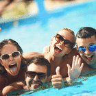 Group of friends enjoying fun moments in a swimming pool, experiencing the vibrant atmosphere offered by DMC Egypt.