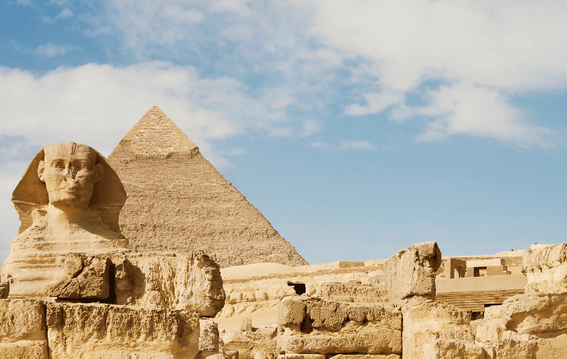 The Great Sphinx and the Pyramid of Khufu in Giza, Egypt, showcasing ancient wonders experienced with DMC Egypt.