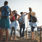 Travelers with backpacks enjoying a scenic overlook, experiencing the wonders of Egypt with DMC Egypt.