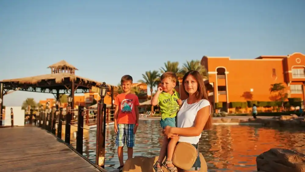 Family vacation sunset by resort lake.